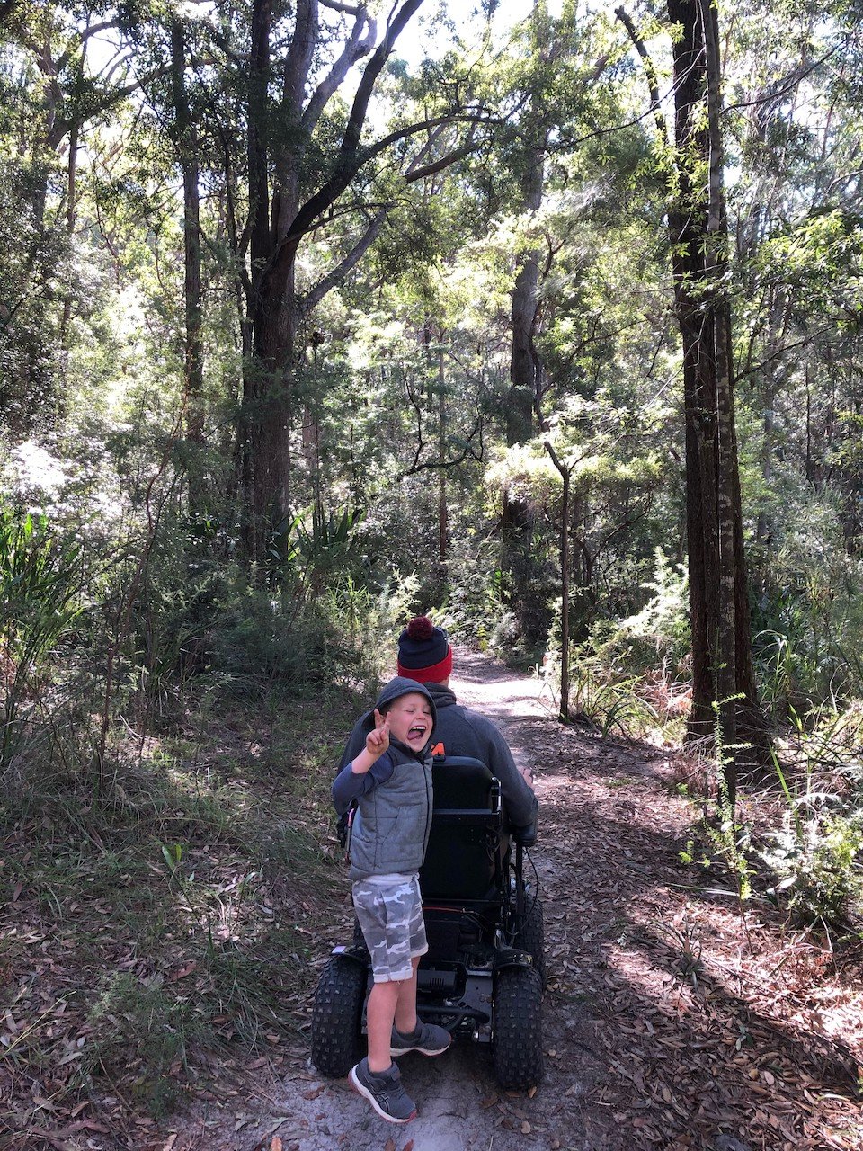 Dad in wheelchar with his kid in nature