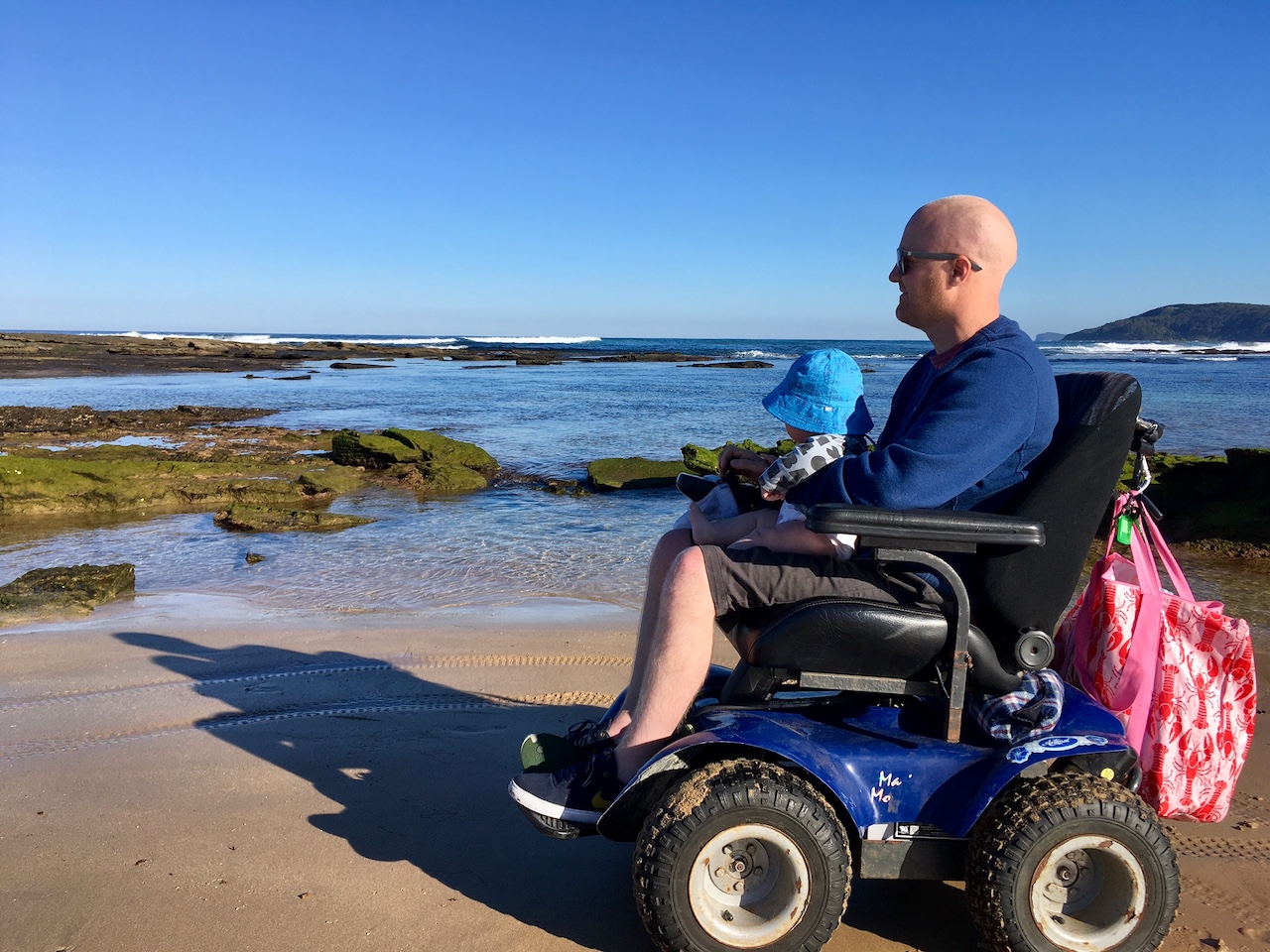 Dad in wheelchair holding his kid