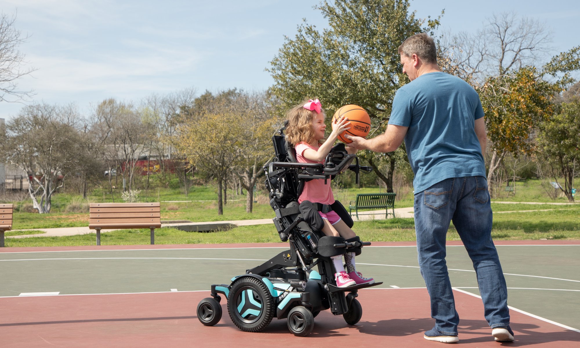 Girl in standing wheelchair playing basketball