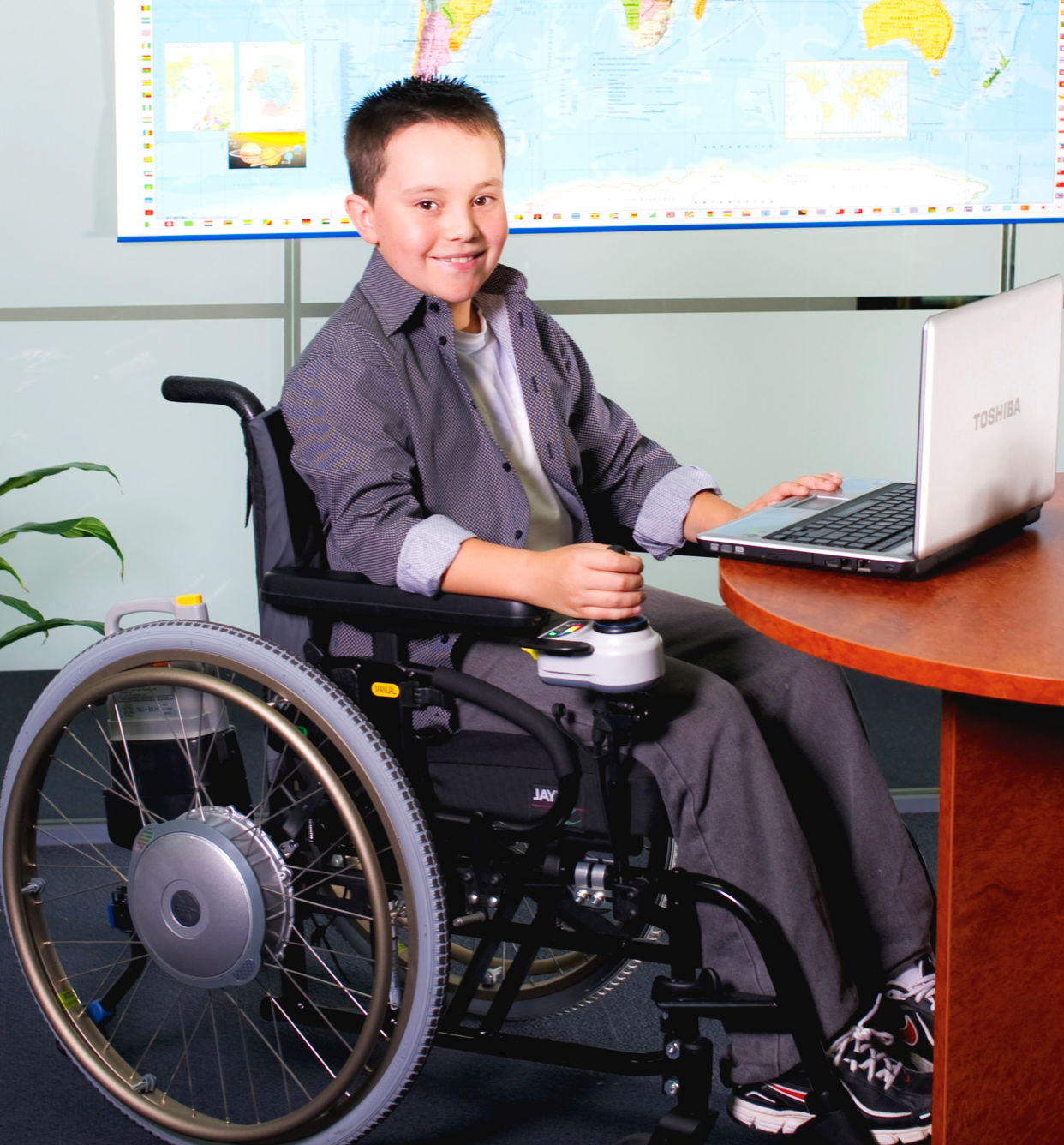 Kid in wheelchair with power assist device