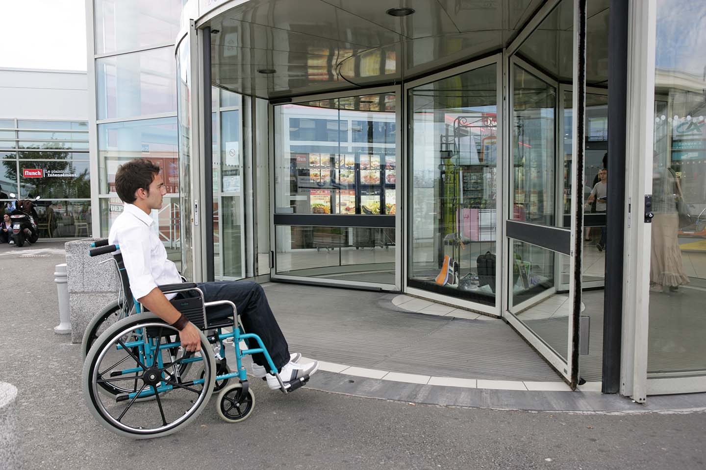 Man in wheelchair entering the building